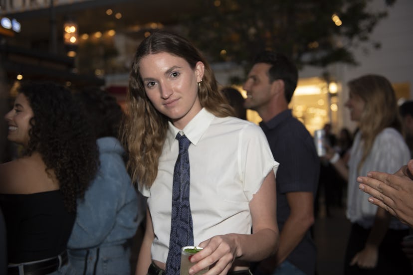 A young woman posing in a white shirt at the performance of Zolita and Gavin Turek