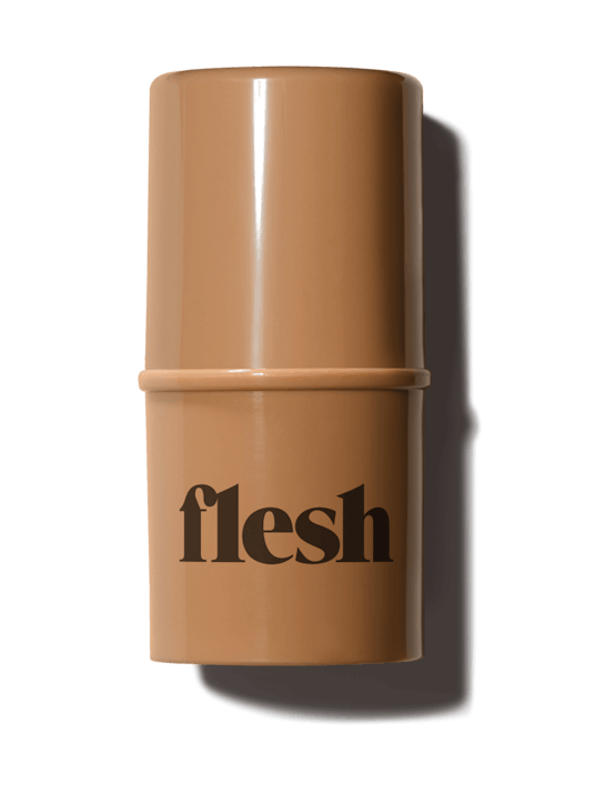 Flesh Beauty's Firm Flesh Thickstick foundation in light brown packaging with "Flesh" written in dar...