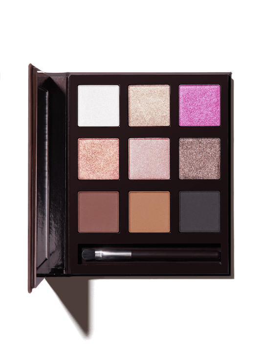 Flesh Beauty's Fleshcolor eyeshadow palette in black packaging with a mini brush on the side 