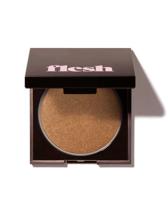 Flesh Beauty's Flesh to Flesh highlighting powder in black packaging 