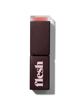 Flesh Beauty's Fleshy Lips lipstick in black packaging with a translucent top of its lid 