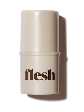 Flesh Beauty's Touch Flesh highlighting balm in beige packaging with dark brown writing 