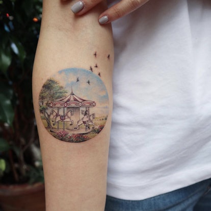 Carousel tattoo on a woman tattooed by Eva Karabudak.