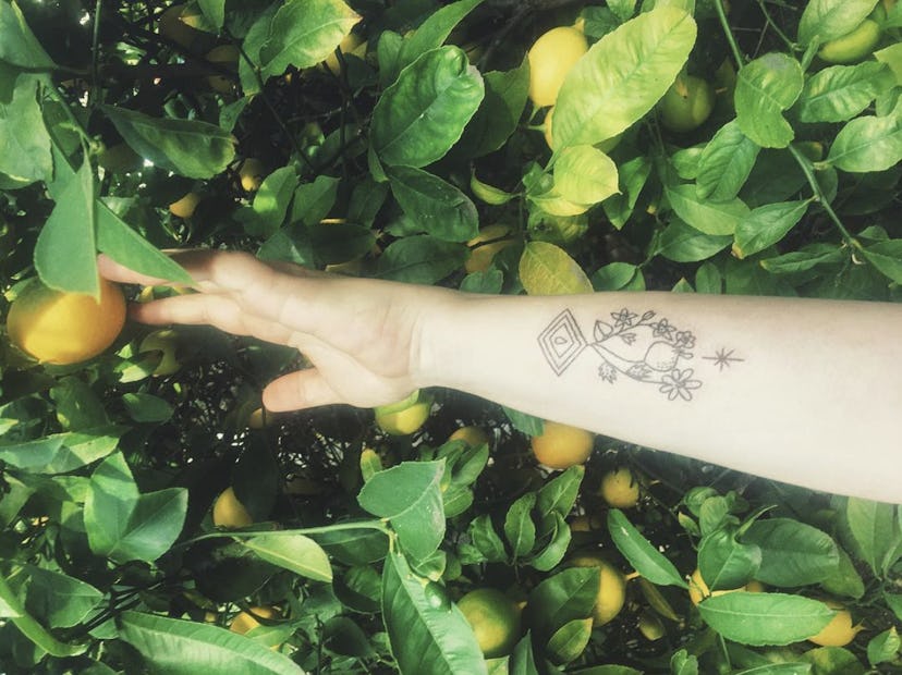 Tattoo  with flowers and parallelogram shape tattooed by Ash Glynn.
