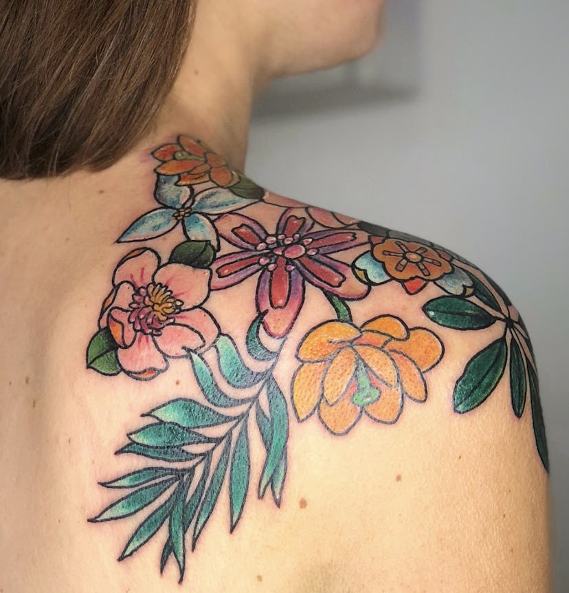 Flower tattoo with branches tattooed by Jes Dwyer.