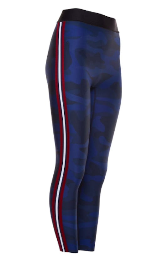 Black and blue Ultracor leggings with red and white stripes down the side and a faint camo pattern i...