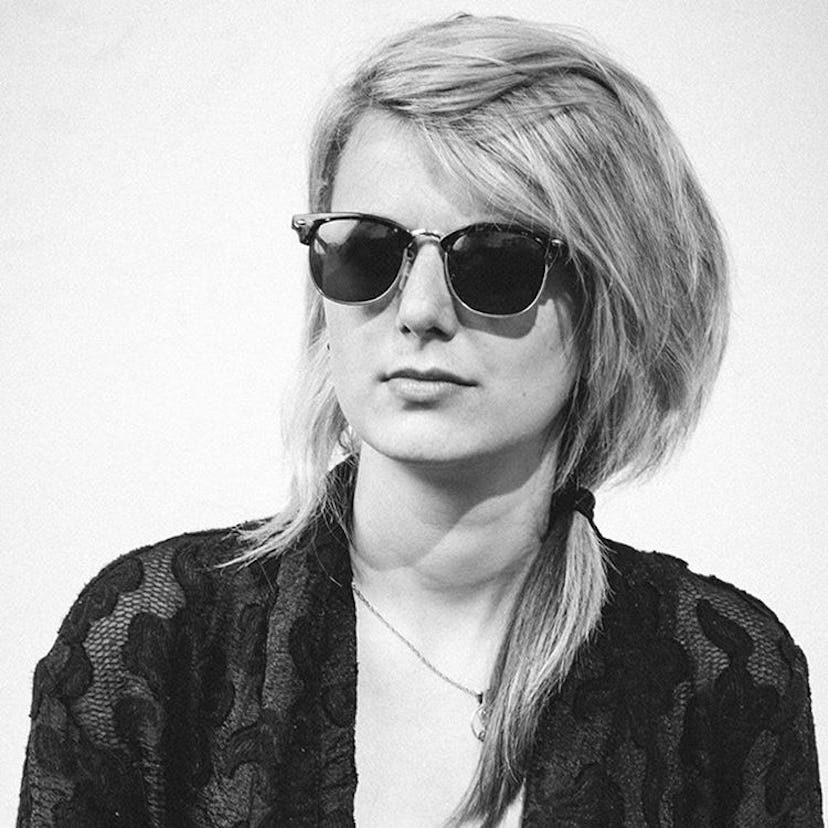 Louise Bartle posing for a photo while wearing black sunglasses 