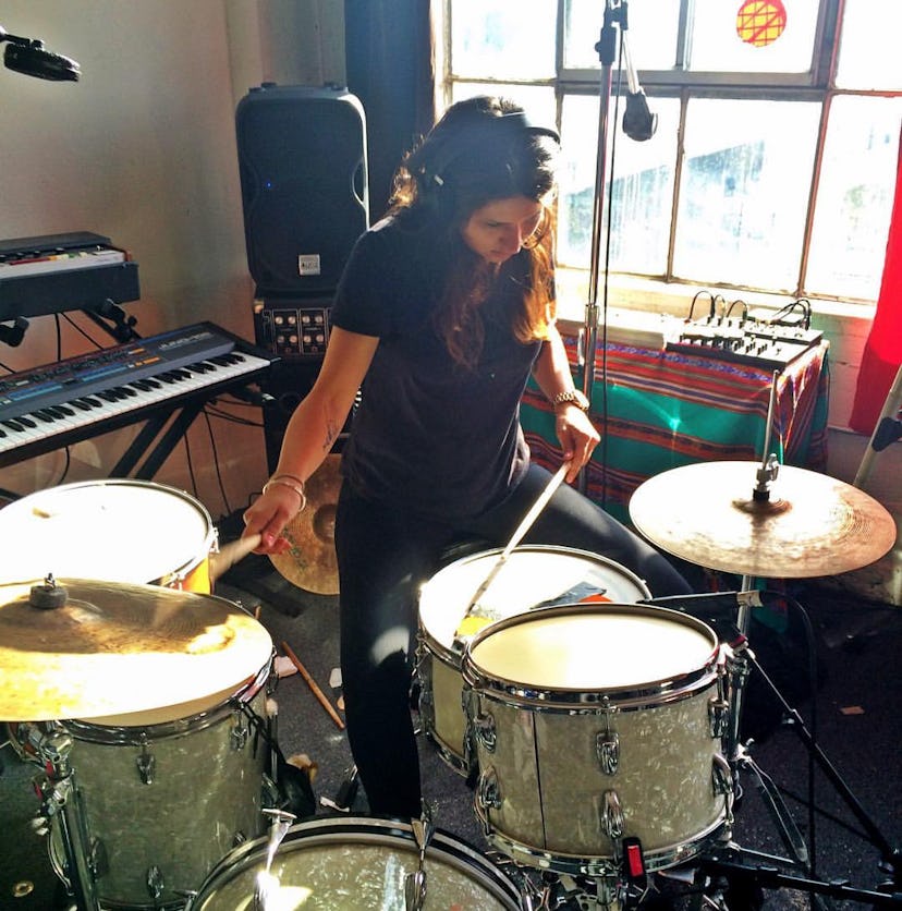 Stella Mozgawa playing drums in a room