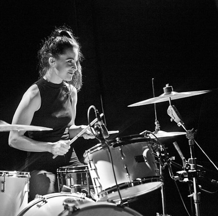 Fay Milton sitting in front of drums