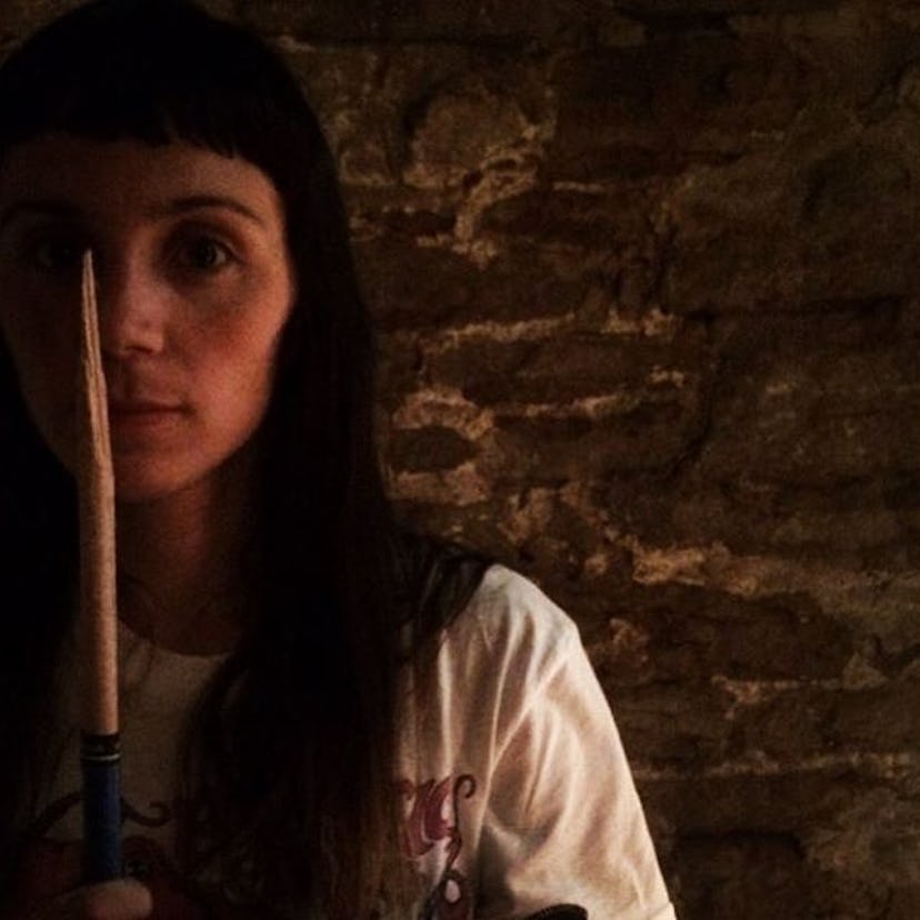 Antonela Périgo posing for a photo with a drum stick