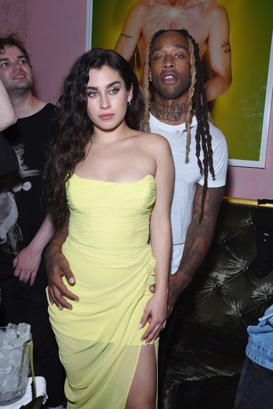 Lauren Jauregui in a yellow dress, posing with her boyfriend Ty Dolla Sign at a party