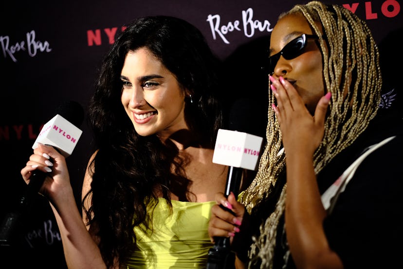 Lauren Jauregui and DJ Zuri Marley posing together with microphones in their hands