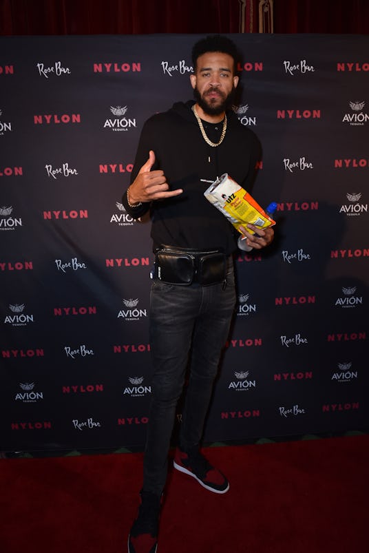 Javalee McGee posing with chips in his hands at Lauren Jauregui's Nylon party