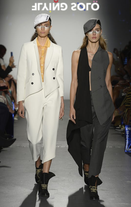 Two models in suits and flat caps by Wilde Vertigga, walking the Flying Solo runway show 