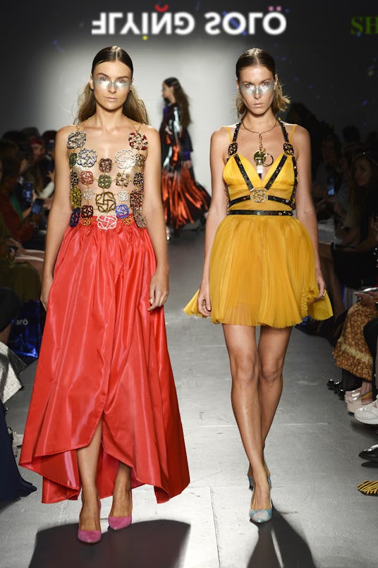 Two models at the Flying Solo show wearing Ali Haider dresses in yellow and red 