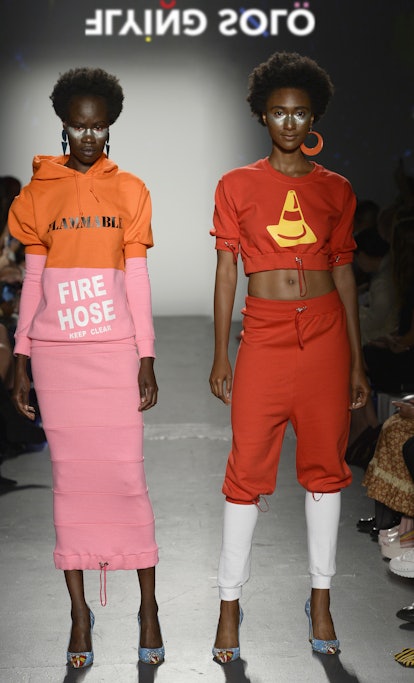 Two models walking the Flying Solo runway wearing Gavea: a pink and orange sweatshirt dress and a re...
