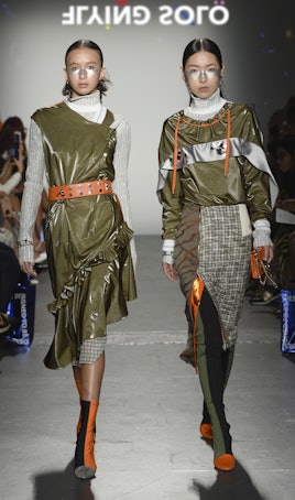 Two models in the Flying Solo show in Daniel Silverstain: a green dress with a grey turtleneck and a...