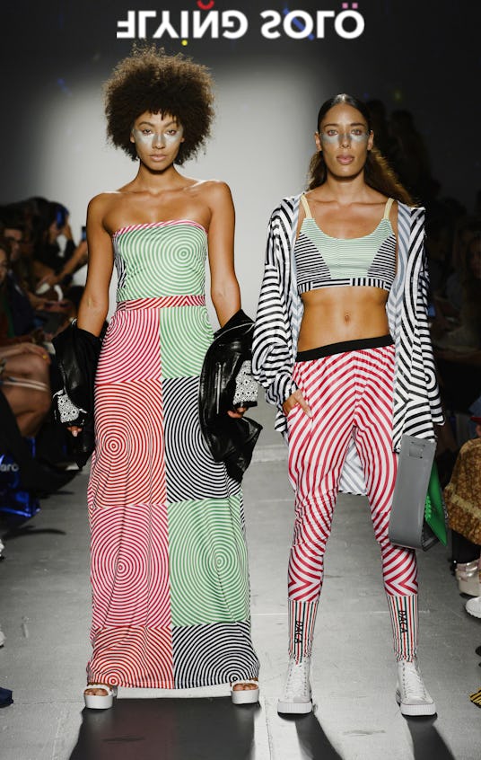 Two models in the Flying Solo show in Ricardo Seco: a green and red top and skirt set and a workout ...