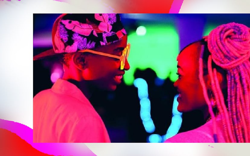 A scene in neon lights from Rafiki with two characters smiling at each other 