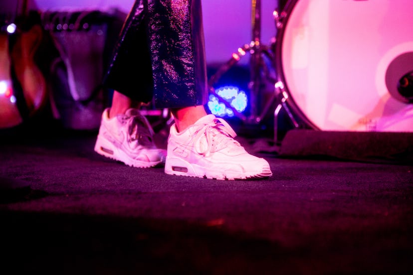 A close-up shot of Katelyn Tarver's feet wearing chunky white sneakers