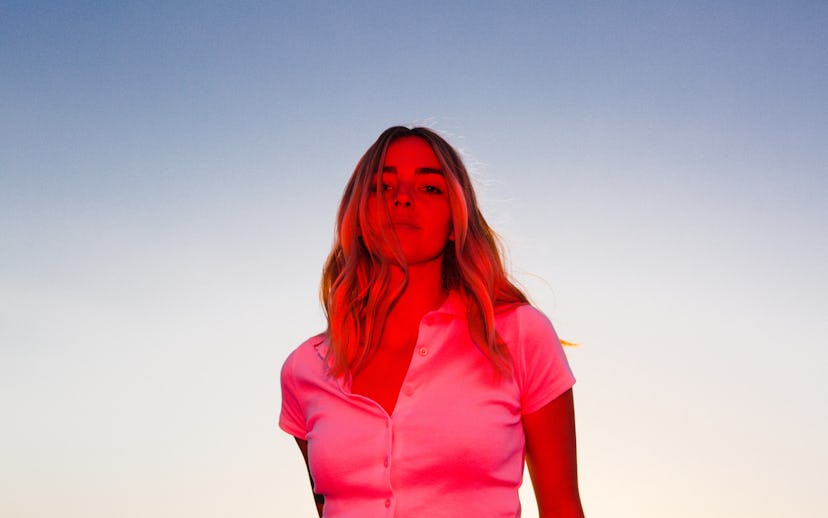 Katelyn Tarver posing in a pink shirt