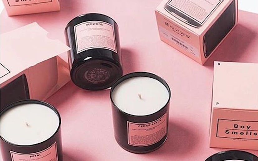 Black candle containers with pink stickers and package boxes for the candles by Boy Smells by founde...