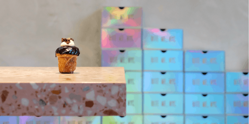 A cruffin with chocolate on top placed on a countertop at Supermoon Bakehouse