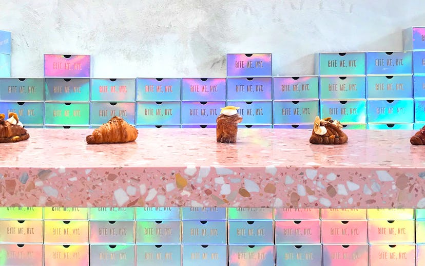 Food boxes with the words "Bite me, NYC" on them and five types of pastries on the table in front of...