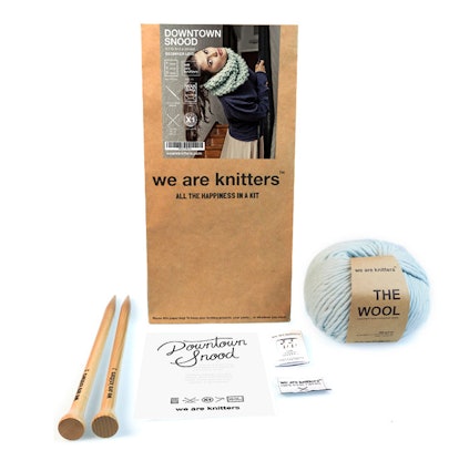 We Are Knitters' Downtown Snood Knitting Kid with wooden knitting needles and blue yarn