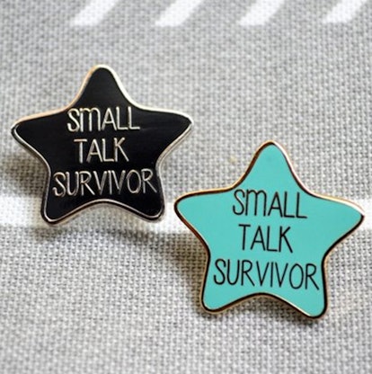 CynicalRedHead's Small Talk Survivor pin in turquoise and black, in the shape of a star 