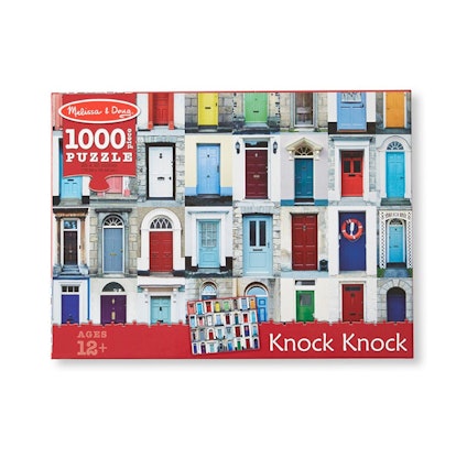 Melissa & Doug's Knock Knock Doorways jigsaw puzzle box with illustrated doors all over it 