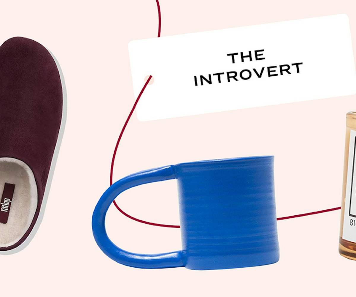 A candle, cup and slippers with card "The introvert"
