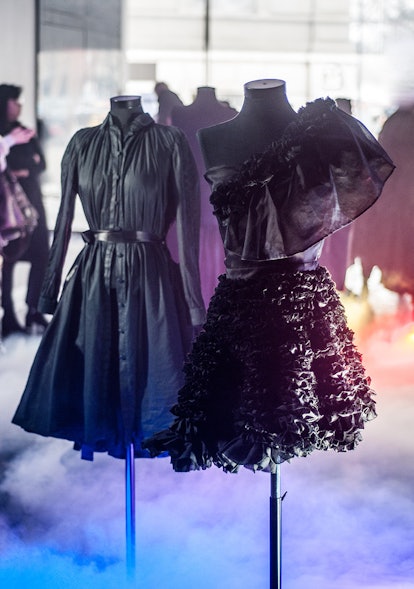 Two jet black dresses, one with ruffles and one looking like a long shirt, created by designer Xuan-...