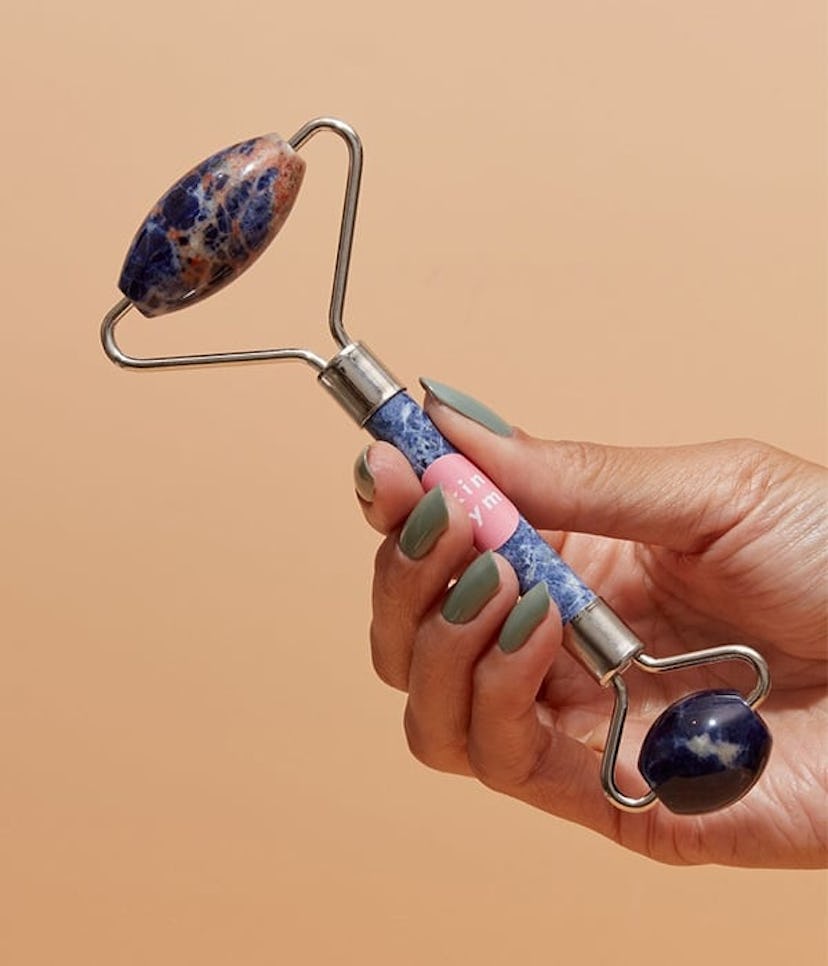 Skin Gym's Blue Soladite facial roller in blue and purple tones 