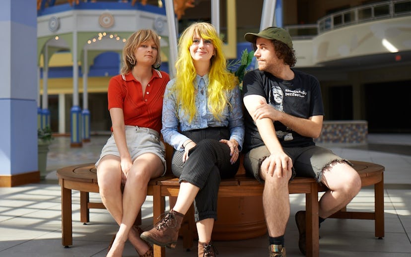 Members of Leggy sitting on a wooden bench