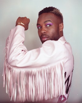 Todrick Hall posing in a pastel pink fringe jacket 