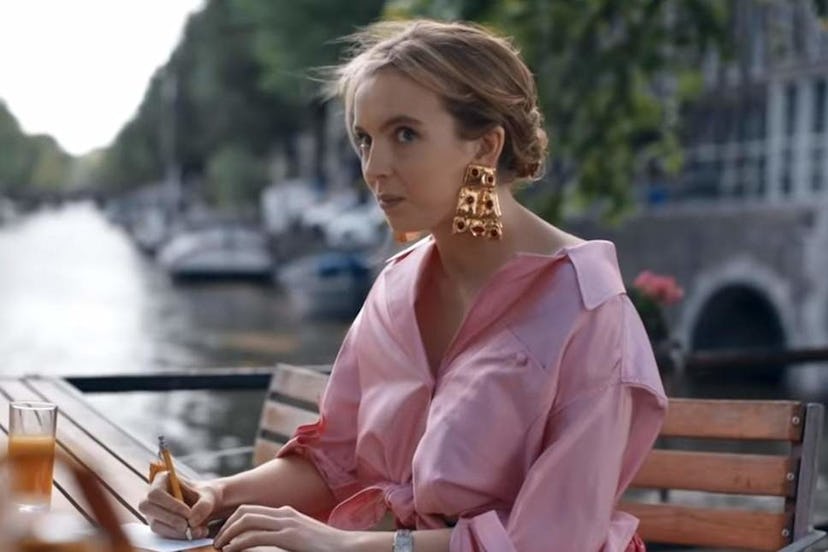 Jodie Comer wearing a beautiful pink silky shirt in a scene of Killing Eve