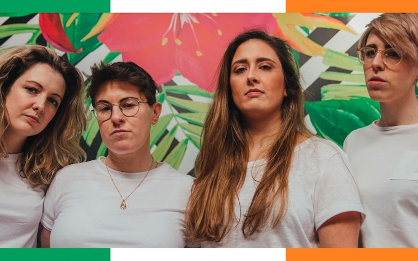 Pillow Queens band members posing in white t-shirts