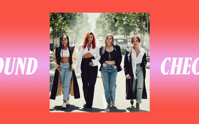 Four young girls wearing white crop tops and shirts while walking down a street