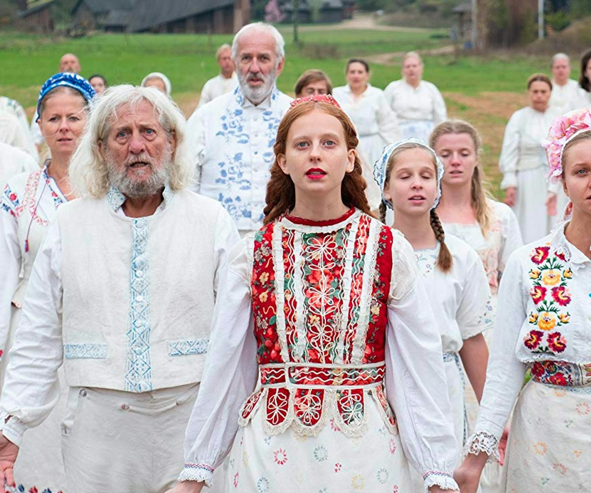 A scene from a movie "'Midsommar" with people in white outfits