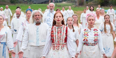 A scene from a movie "'Midsommar" with a few people in white outfits
