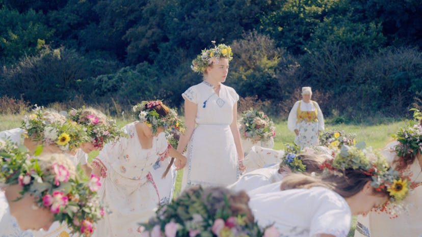 A scene from movie "'Midsommar" with Dani played by Florence Pugh in a white dress and girls around ...