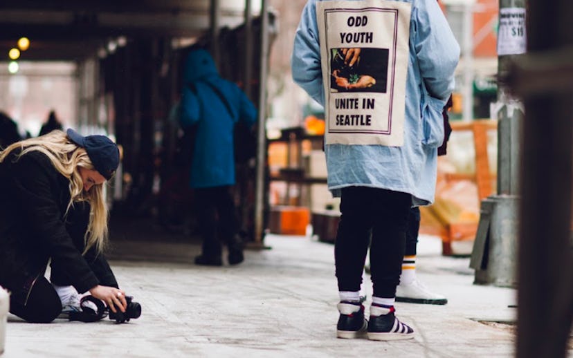 Man wearing a denim jacket with the words "Odd youth unite in Seattle" on the back