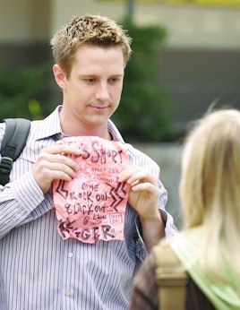 Jason holding a pink paper to Veronica Mars 