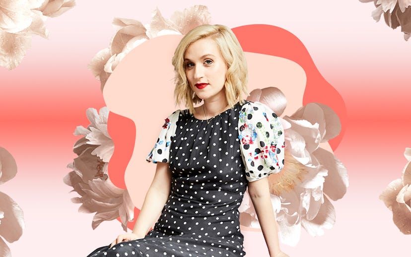 Gabrielle Korn posing in a black dress with white dots in front of a peachy-white floral background