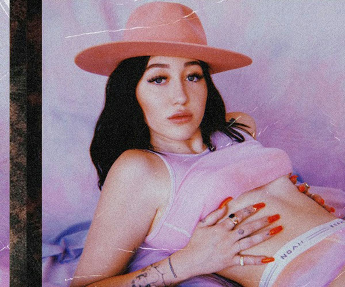 Noah Cyrus in a pink top with a pink hat in a retro picture