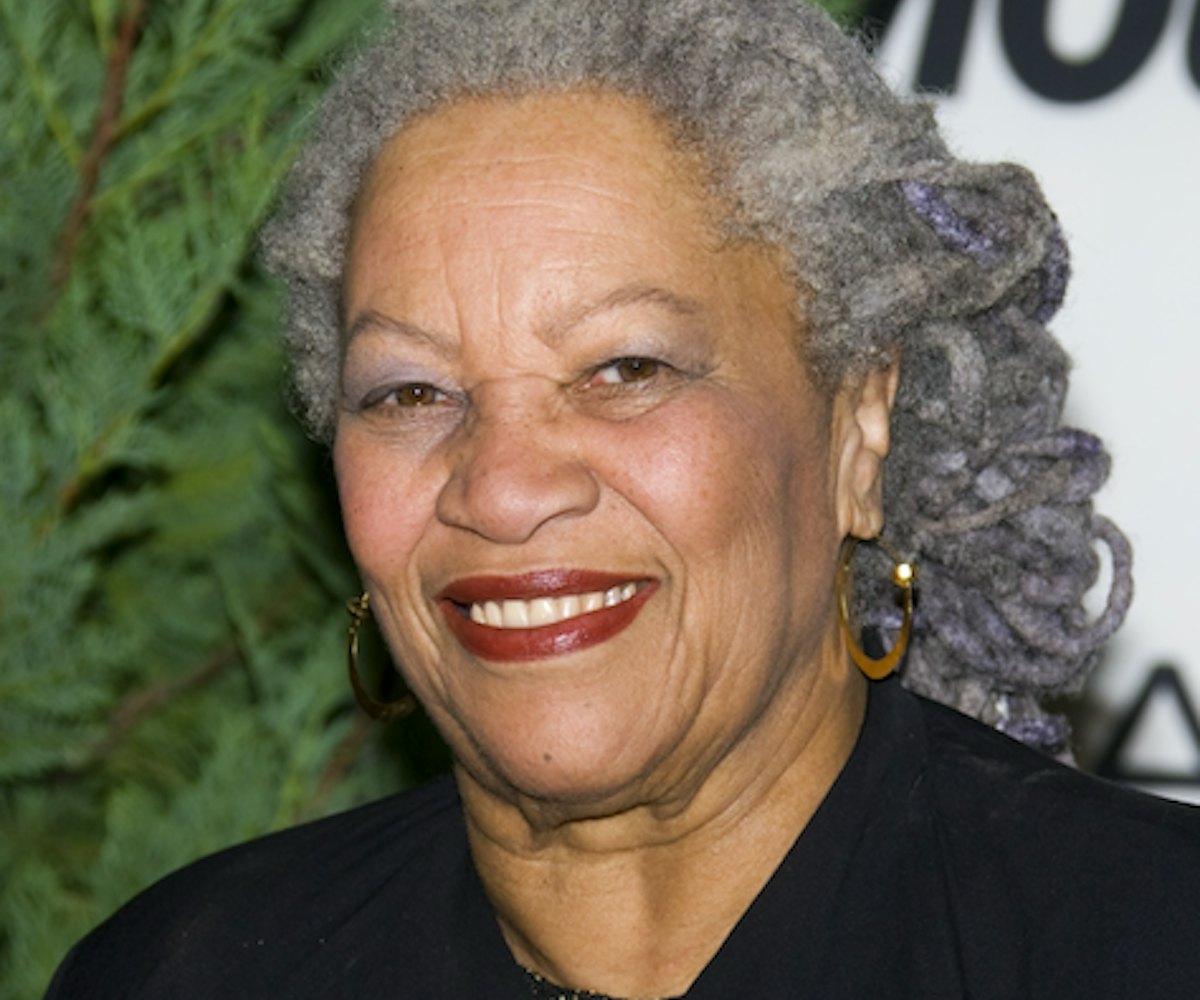 Nobel prize-winning author Toni Morrison wearing a bold red lip and smiling