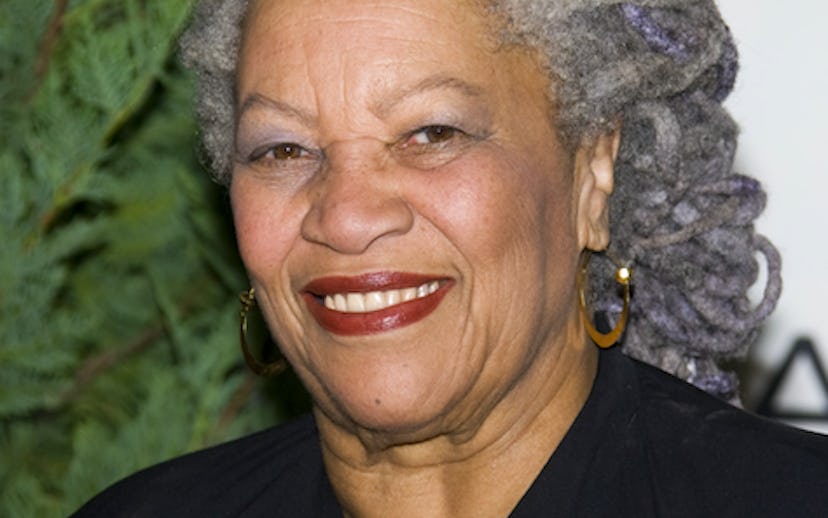 Nobel prize-winning author Toni Morrison wearing a bold red lip and smiling