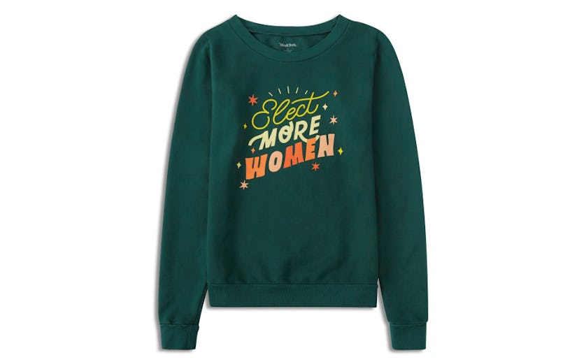 A green shirt that has the words "Elect More Women" on it with a few stars around it