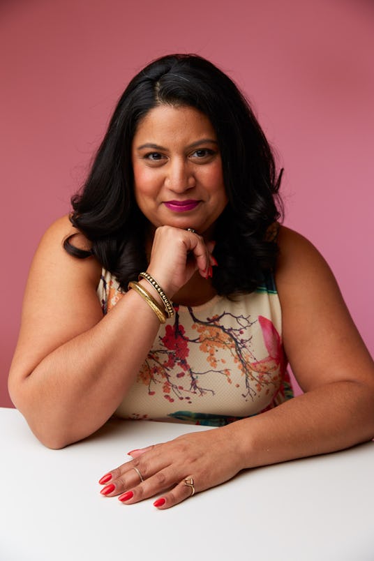 Executive editor of Teen Vogue, Samhita Mukhopadhyay sitting and leaning on a table